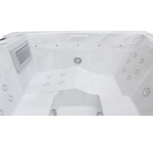 Innenraum des Whirlpools JJSPA Beta 414 mit Massagedüsen an den Sitzen, Filtergehäuse und Wasserfallauslass.