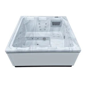 Frontansicht des Whirlpools JJSPA Beta 414 mit weißer Wanne in Marmoroptik, Kopfstützen, Massagedüsen und Filter.